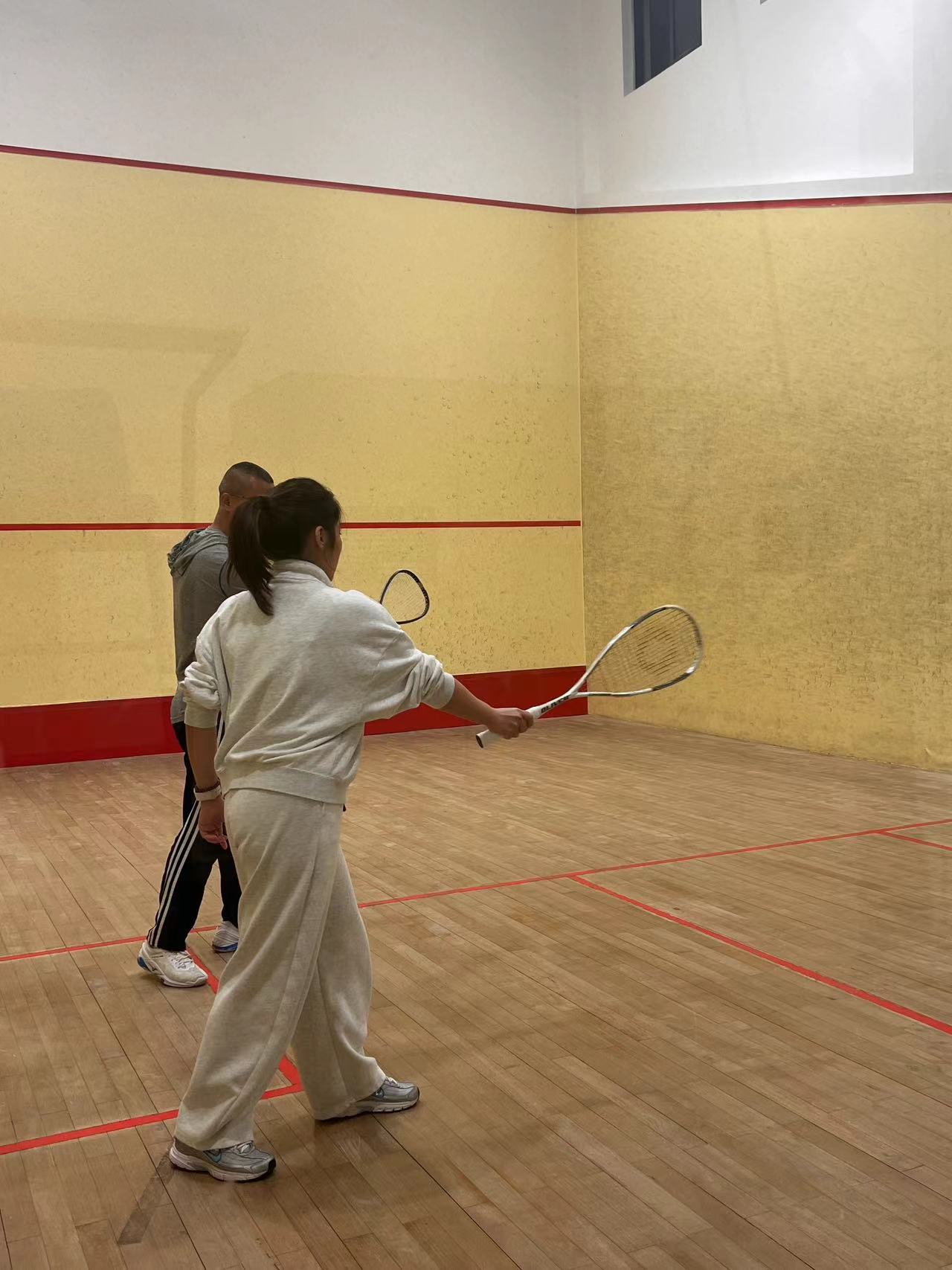 Gloria practicing squash on court
